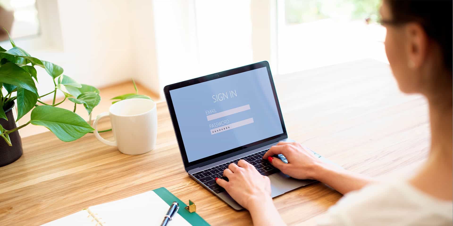 Woman at desk, using laptop